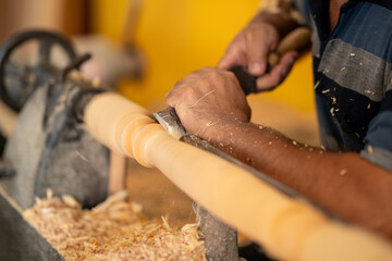 Carpenter working on wood to carving and shaping