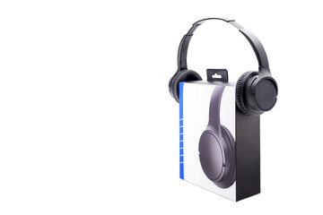 black digital stereo headphones and cardboard box for shipping, on white background