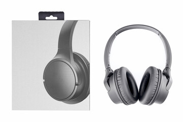 close up of black wireless stereo headphones and paper box on white background, top view