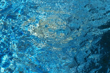 Blue transparent sea surface with bubbles water background