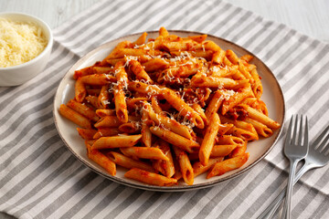 Homemade Pasta Bolognese with Cheese on a Plate, side view.