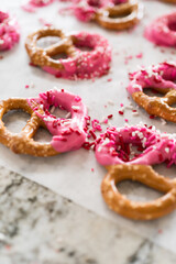 Homemade Gourmet: Delightful Pretzels Adorned with Pink Chocolate and Sprinkles