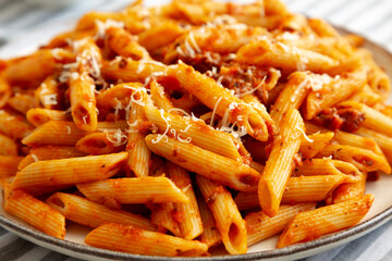 Homemade Pasta Bolognese with Cheese on a Plate, side view. Close-up.