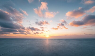 Empty concrete plaza at sunrise over the ocean