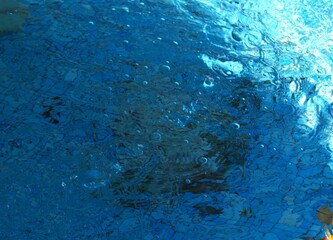Blue transparent sea surface with bubbles water background