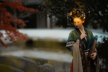 Young woman in traditional clothing by tranquil water.