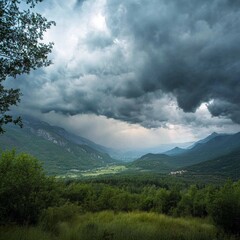 Obraz premium Scenic Mountain Landscape Under Dramatic Cloudy Sky with Valley