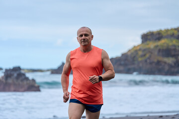 Man running on the black sand beach