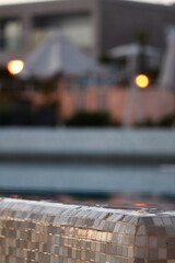 Relaxing Evening by the Poolside with Reflections and Warm Light