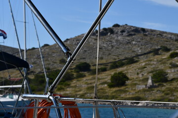 Scenic Sailboat View with Mountainous Background Capture in Clear Water Harbour