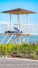 Lifeguard tower by the lake with mountains in the background
