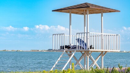 Lifeguard tower by the lake with mountains in the background
