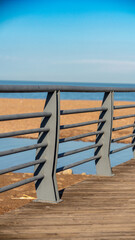 Seaside metal railing with beach and sea view