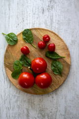 Tomatoes and Cherry tomatoes on a wooden tray
