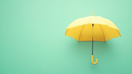 Obraz premium A minimalistic pastel yellow umbrella placed on a mint green backdrop.