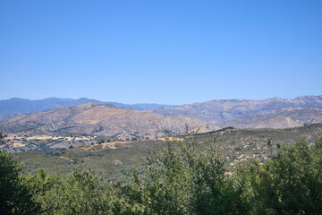 Mountain Valley Overlook with Grassy Foreground and Distant Hills
