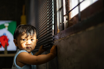 Sunlight Outside The Window Shines On The Face Of A Toddler