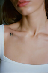 Minimalist Tattoo: 'Hi' on a Woman's Shoulder