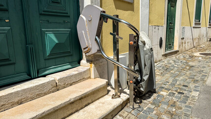 A forgotten stairlift whispers timeless tales of accessibility and cobblestone journeys, echoing...