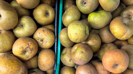 A bounty of russet apples nestles in crates evokes Apple Day charm and cider-making festivities'...
