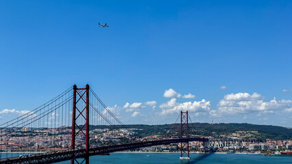 Ethereal aircraft glides above Lisbon's sunlit bridge, celebrating Dia de Portugal, merging urban...
