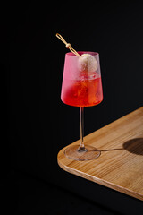 Refreshing cocktail with a unique garnish on a wooden table