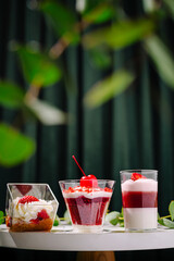 Delicious desserts in stylish glasses presented on a table