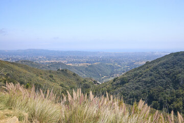 Mountain Valley Overlook with Grassy Foreground and Distant Hills
