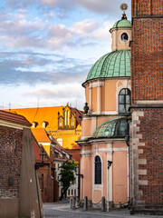 Beautiful view of a Gothic brick Collegiate Church of the Holy Cross, St Bartholomew, surrounded by a bright cloudy sky, Wroclaw, Poland