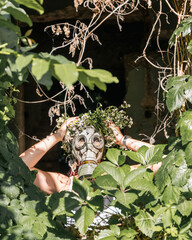 Woman in gas mask at destroyed building