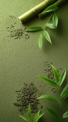 Dried tea leaves and bamboo stalks on a green background.