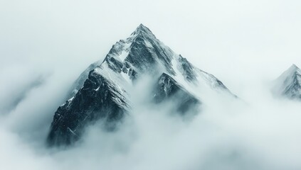 Misty mountain peak, shrouded in clouds