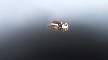The house is sitting isolated in the middle of the ocean.