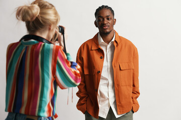 young man working with female colleague taking photo, business workplace, Gen Z coworkers socializing and collaborating in modern environment