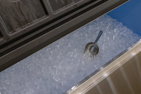 Ice cubes store in ice making machine for clean product. Ice cube maker. Cube ice machine. Suitable for small beverage shops.
