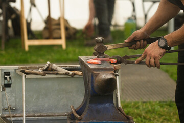 hammer hitting glowing red horseshoe