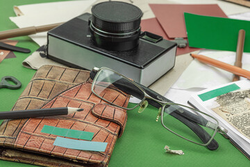 Flat lay with vintage camera, cassette, notebook, key and research tools on green background