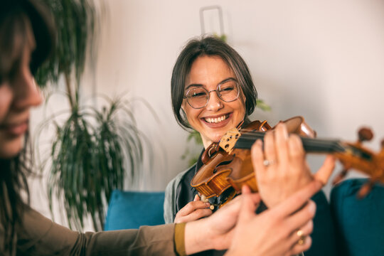 Music Teacher Teaching Student How To Hold Violin