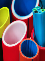 Vibrant collection of colorful plastic tubes arranged in various shapes and sizes for crafting and design projects
