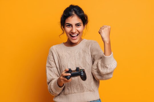 Happy player rejoicing in victory on console studio scene Thrilled Indian woman boasting about defeating all foes with gamepad camera B