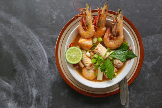 Tom yam soup originating from Thailand. Tom yum is made with shrimp, chili, lime, chicken, fish, or seafood and mushrooms.
