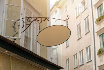 Retro style empty signage board with wrought iron support, ideal for traditional business mockups,...