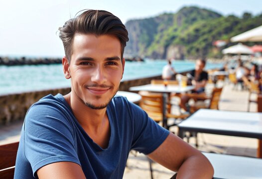 Portrait of a man sitting at an outdoor cafe near the seaside with copy space - Powered by Adobe
