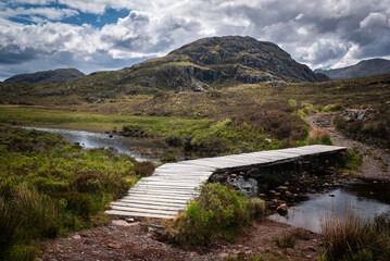 A summer HDR image of the footbridge at the start of thenbad na sgalag pinewood trail in flowerdale...