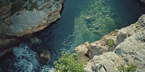Rocky coastline with clear blue water and underwater visibility.