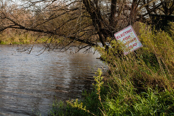Sign "Electronic Fish Barrier Ahead"  in the river at Horicon National Wildlife Refuge, Wisconsin