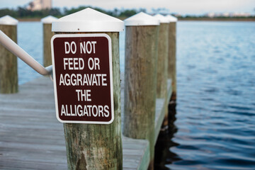 Sign on the dock at Gulf State Park, Gulf Shores, Alabama, advising everyone to leave the alligators alone
