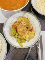 Top angle vertical shot of Paraguayan cuisine panache de verduras (mixed vegetable dish) on dining table, surrounded with vegetable soup and rice. The dish is a blend of Guarani and Spanish Influence.