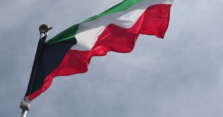 Video of Kuwait's Flag in 4K format. The flag of Kuwait, waving against the background of the blue sky, is the national symbol of Kuwait. Independence Day. The flag is in close-up. Great for news.