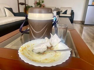 indian lunch box and crockery on table 
